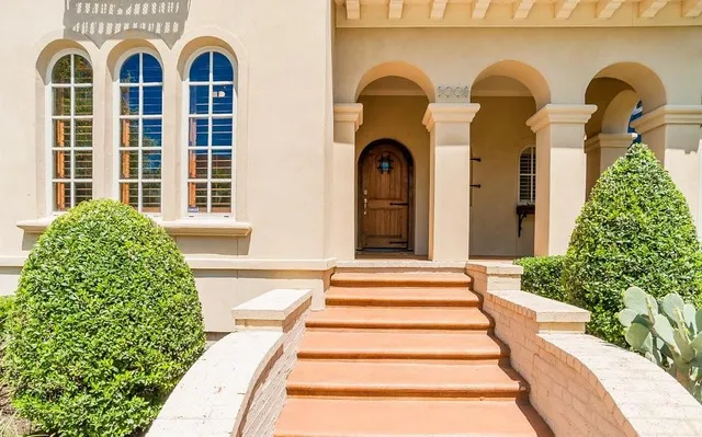 a view of a brick house with large windows