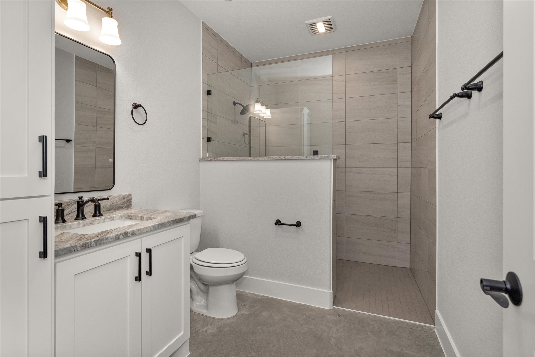 12744 Oak Barrel Road Willis, TX 77378 - Photo 34 of 50 The secondary bathroom features a nicely sized walk-in shower designed for both comfort and functionality. A built-in niche provides convenient storage for shampoo, soap, and bath essentials, keeping the space organized and streamlined.