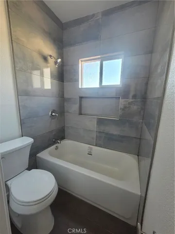 a bathroom with a toilet a sink and bathtub