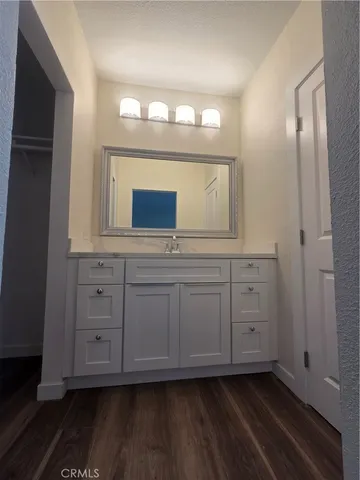 a bathroom with a granite countertop sink and a mirror