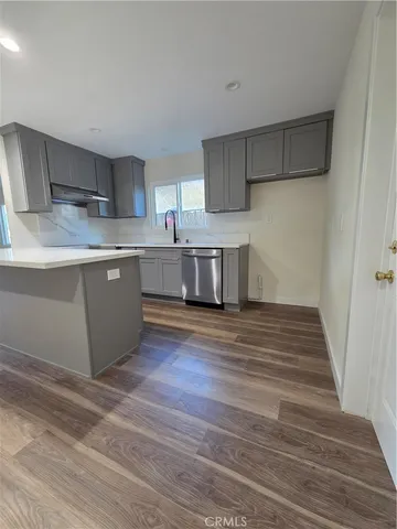 a kitchen with stainless steel appliances granite countertop a sink and stove top oven