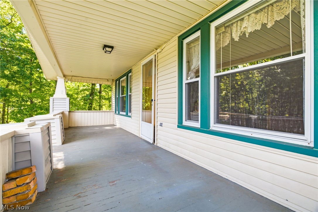 759 Runkle Avenue Ashtabula, OH 44004 - Photo 5 of 40 Covered porch featuring tan siding, teal window trim, and entry door