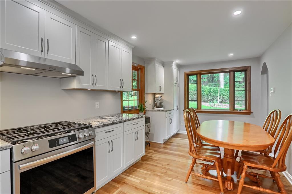 836 Harmony Road Pittsburgh, PA 15237 - Photo 22 of 46 a kitchen with stainless steel appliances granite countertop a stove a sink dishwasher and cabinets with wooden floor