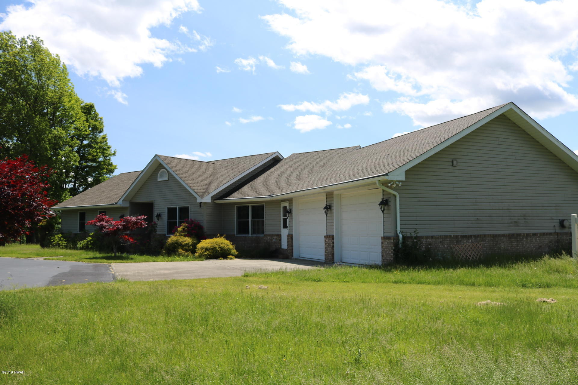 53 Savitz Road Lake Ariel, PA 18436 - Photo 1 of 53 a front view of house with yard and green space