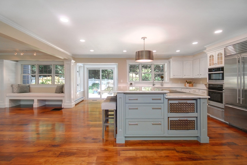 53 Sarah Way Concord, MA 01742 - Photo 11 of 42 a kitchen with stainless steel appliances kitchen island granite countertop a stove and cabinets