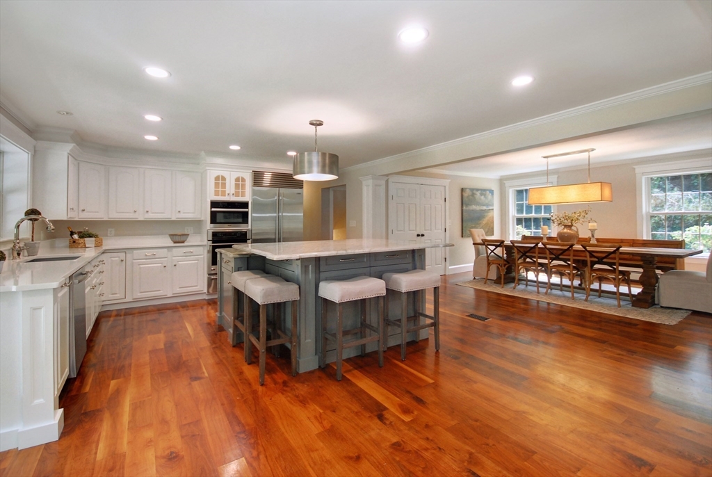 53 Sarah Way Concord, MA 01742 - Photo 13 of 42 a large kitchen with lots of counter space and a wooden floor