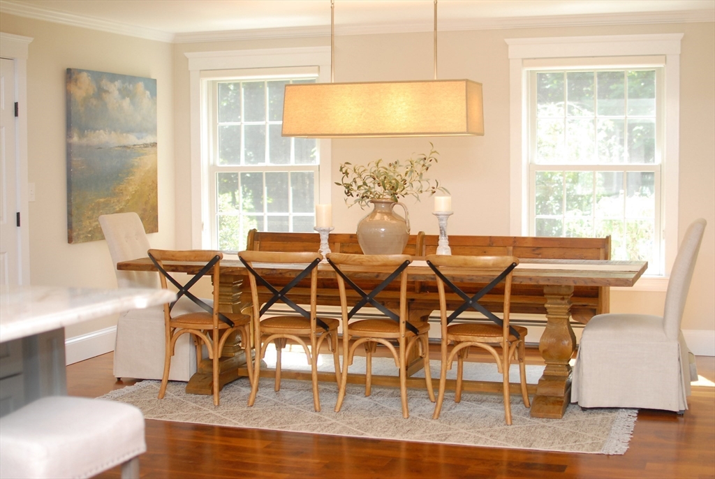 53 Sarah Way Concord, MA 01742 - Photo 14 of 42 a dining room with furniture a chandelier and wooden floor