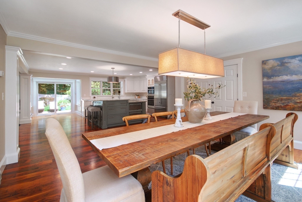 53 Sarah Way Concord, MA 01742 - Photo 15 of 42 a dining room with furniture a chandelier and wooden floor