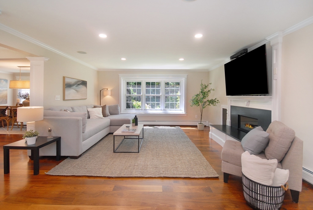 53 Sarah Way Concord, MA 01742 - Photo 18 of 42 a living room with fireplace furniture and a flat screen tv