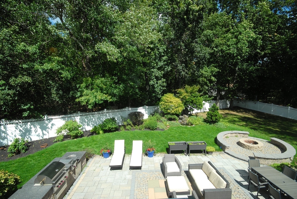 53 Sarah Way Concord, MA 01742 - Photo 2 of 42 a view of a patio with a table chairs potted plants and a park