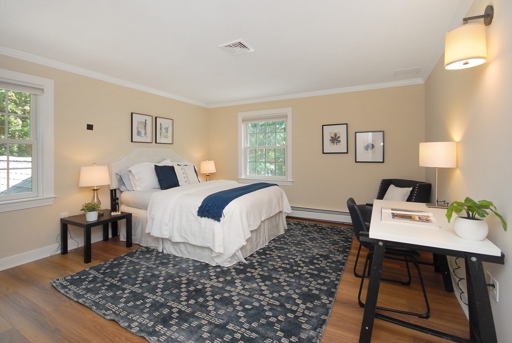 53 Sarah Way Concord, MA 01742 - Photo 29 of 42 a bed room with a bed and a table