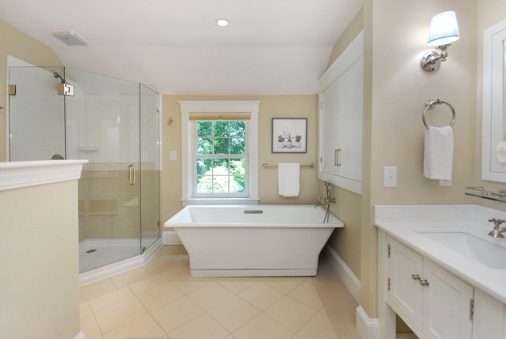 53 Sarah Way Concord, MA 01742 - Photo 30 of 42 a bathroom with a bathtub a shower a sink and a window