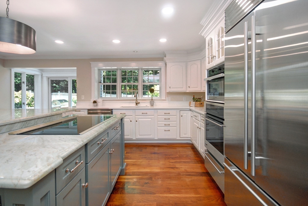 53 Sarah Way Concord, MA 01742 - Photo 8 of 42 a large kitchen with a sink and stainless steel appliances