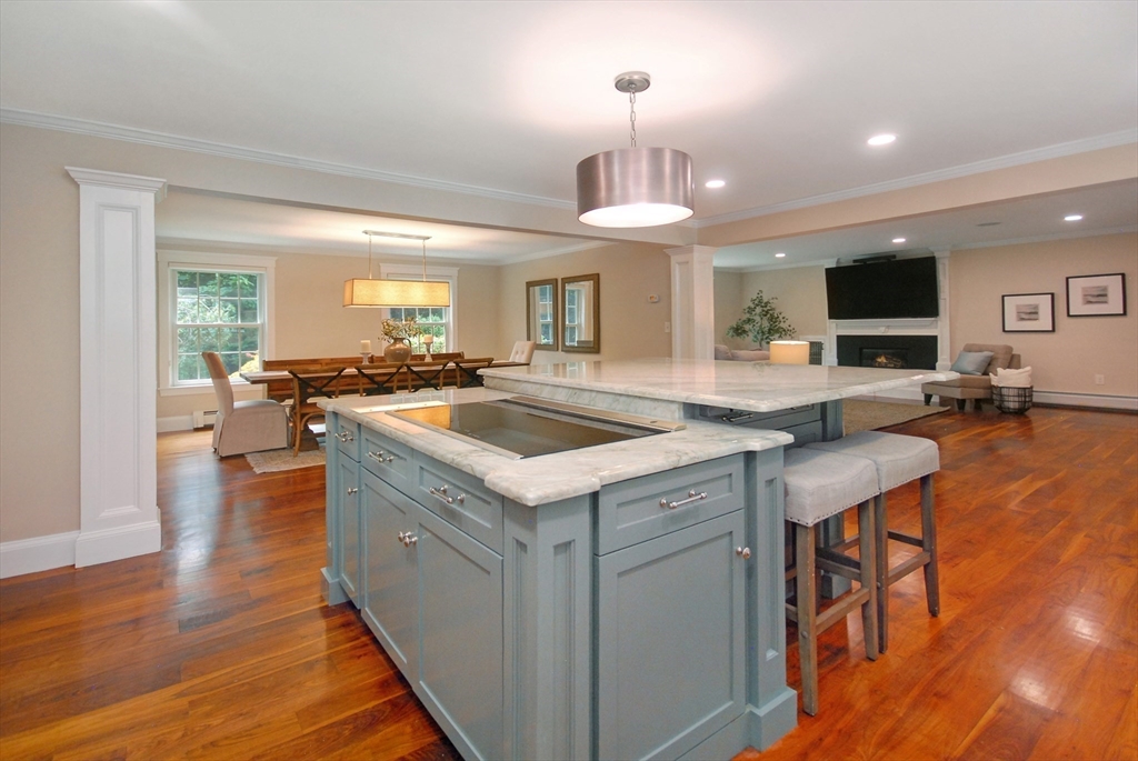 53 Sarah Way Concord, MA 01742 - Photo 9 of 42 a kitchen that has a lot of cabinets a sink and a wooden floor