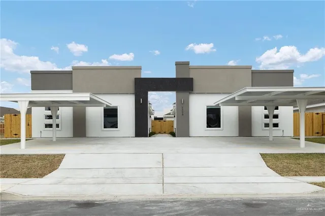 a large white building with kitchen view and windows