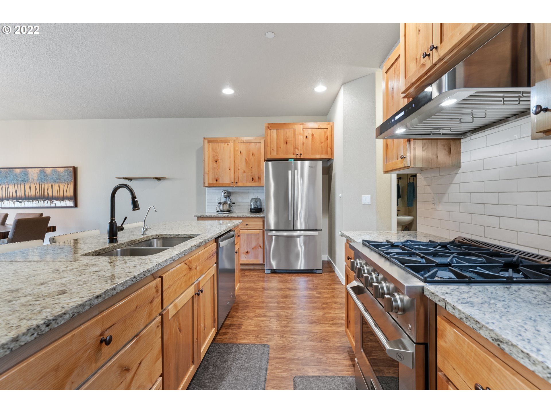 77 North 41st Place Ridgefield, WA 98642 - Photo 8 of 31 a kitchen with stainless steel appliances granite countertop a sink stove and refrigerator