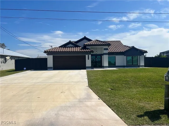 a front view of a house with a garden