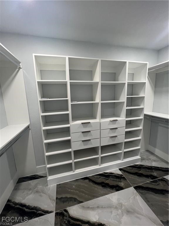 1215 Northwest 38th Avenue Cape Coral, FL 33993 - Photo 18 of 35 a view of walk in closet with empty racks