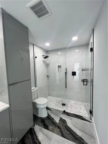a bathroom with a sink toilet and shower