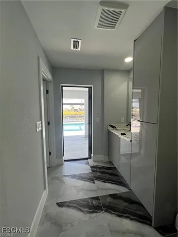 a bathroom with a sink a mirror and a shower