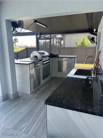 a kitchen with stainless steel appliances kitchen island a stove a sink and a refrigerator
