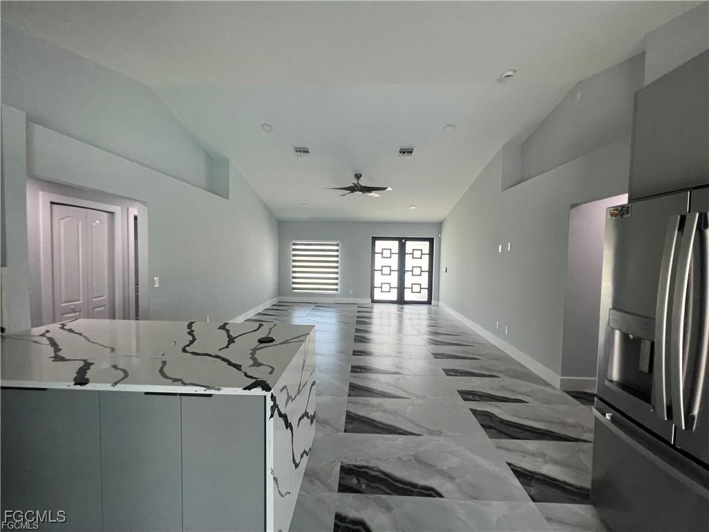 1215 Northwest 38th Avenue Cape Coral, FL 33993 - Photo 3 of 35 a view of a refrigerator in kitchen and an empty room