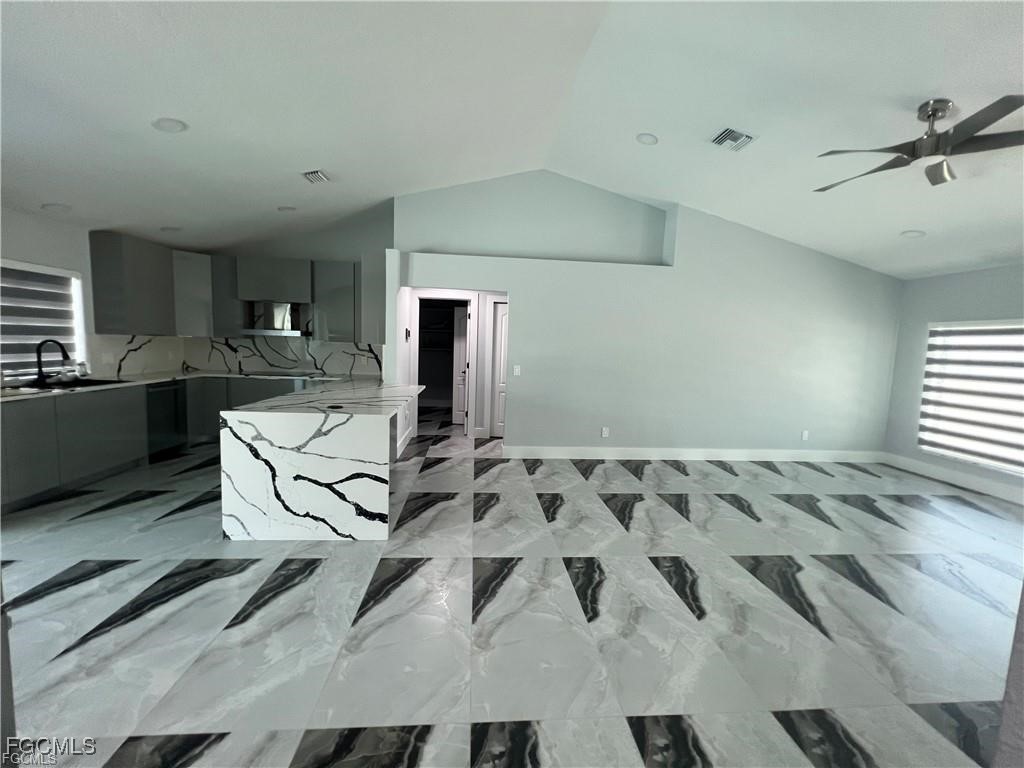 1215 Northwest 38th Avenue Cape Coral, FL 33993 - Photo 5 of 35 a living room with furniture and a flat screen tv