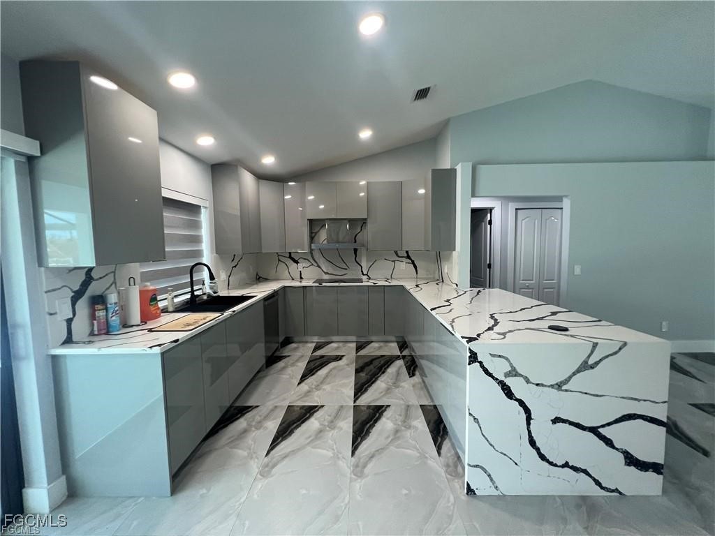 1215 Northwest 38th Avenue Cape Coral, FL 33993 - Photo 7 of 35 a large white kitchen with a large window