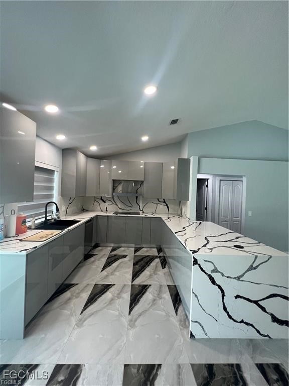 1215 Northwest 38th Avenue Cape Coral, FL 33993 - Photo 8 of 35 a large white kitchen with a sink table and chairs