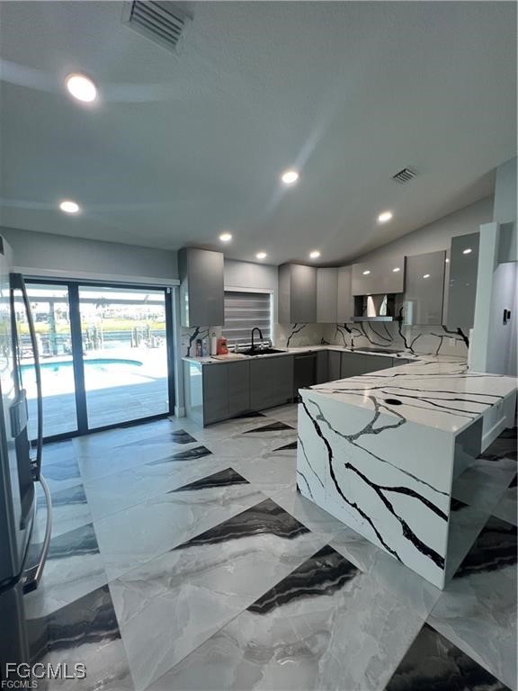 1215 Northwest 38th Avenue Cape Coral, FL 33993 - Photo 9 of 35 a large white kitchen with a large window