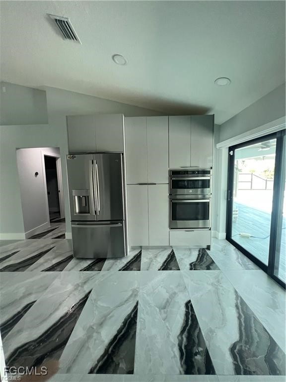 1215 Northwest 38th Avenue Cape Coral, FL 33993 - Photo 10 of 35 a kitchen with stainless steel appliances a microwave a stove and refrigerator