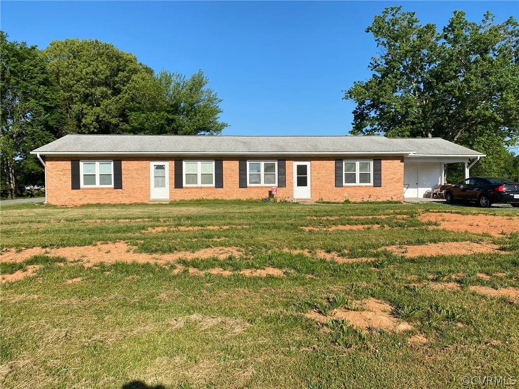 3009 Bibb Store Road Louisa, VA 23093 - Photo 1 of 22 a front view of a house with a garden