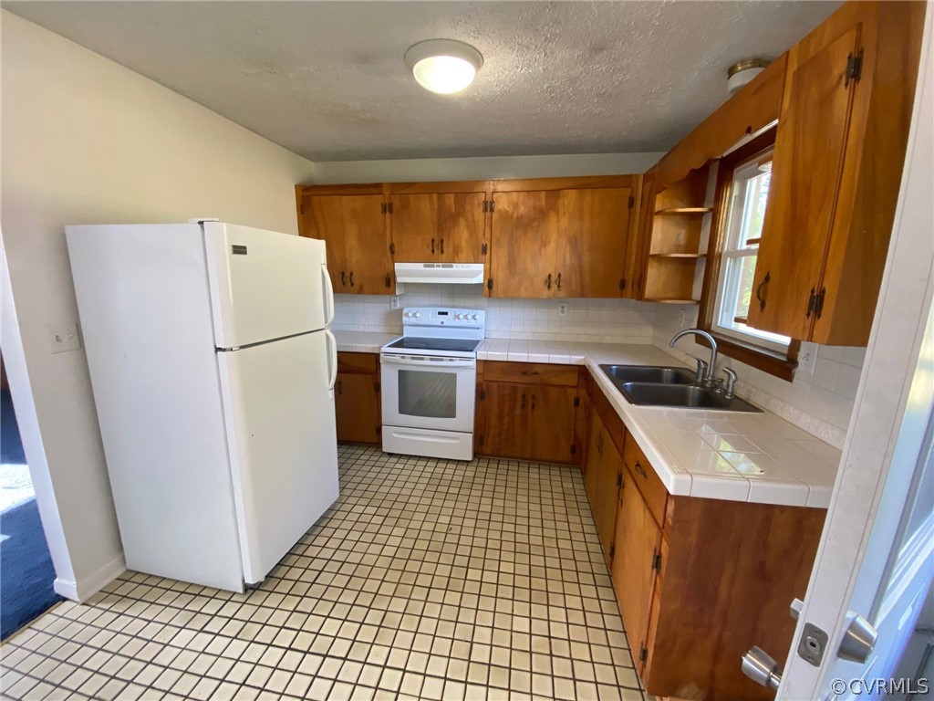 3009 Bibb Store Road Louisa, VA 23093 - Photo 6 of 22 a kitchen with a refrigerator a stove top oven and cabinets