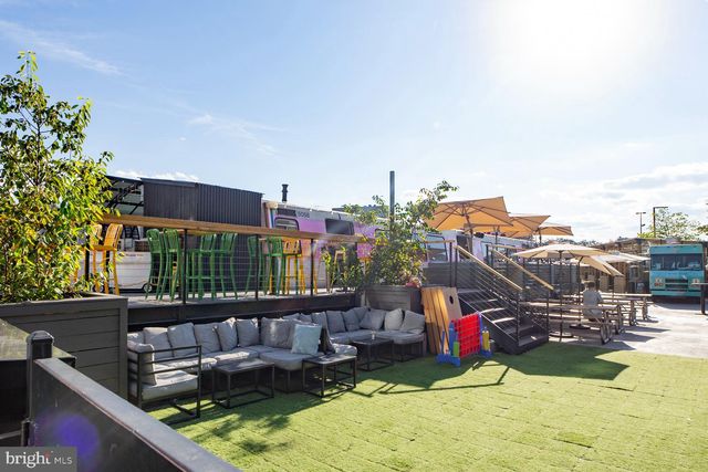 a view of gym equipment and a car parked on the road