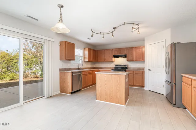 a view of a room with a ceiling fan and a window