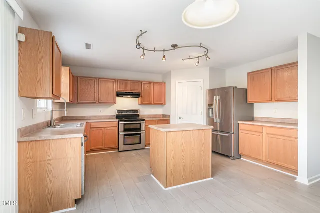 an empty room with a ceiling fan and window