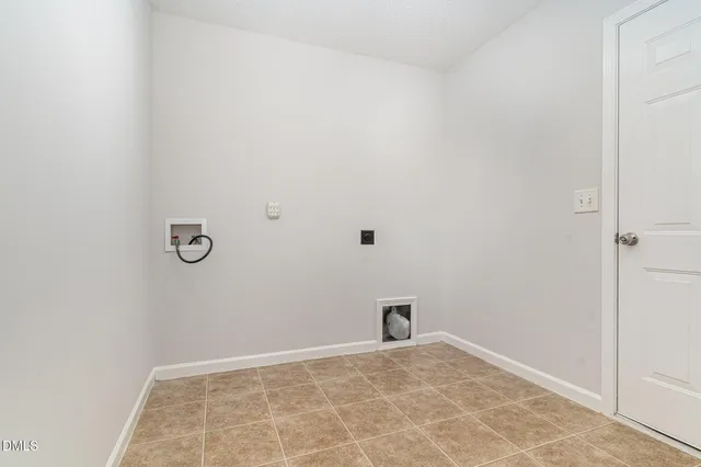a view of a house with backyard and a tree