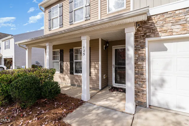 a view of a livingroom with furniture and an empty room