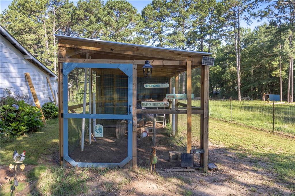 62 McCarthy Road Opelika, AL 36804 - Photo 46 of 74 Outdoor structure featuring a screened enclosure, wood frame construction, and a metal roof