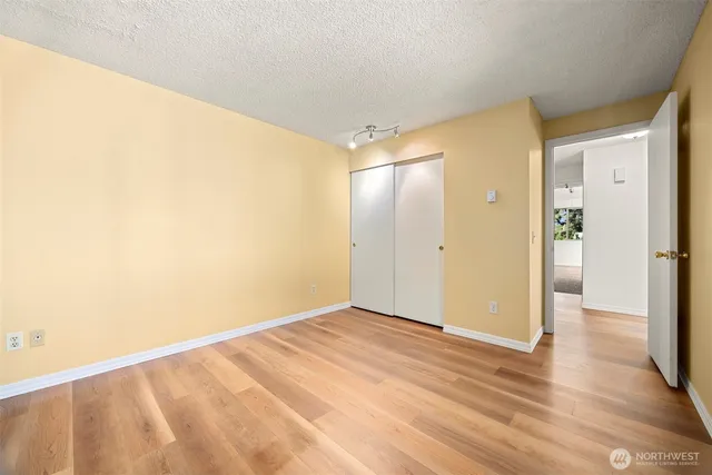 a bathroom with a granite countertop sink a toilet and a mirror