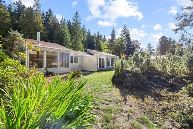 a view of a house with a yard and plants