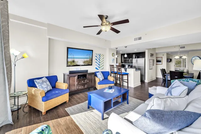 a living room with furniture and kitchen view