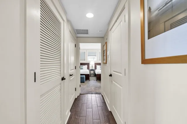 a view of a hallway with wooden floor and staircase
