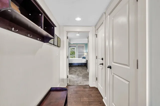 a view of a hallway with white walls and stairs