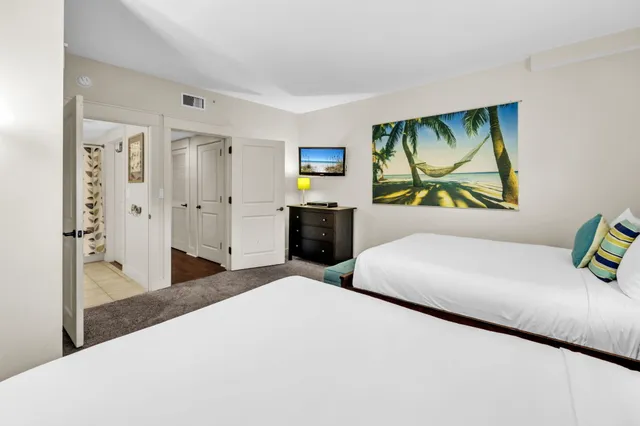 a bedroom with a bed and painting on the wall