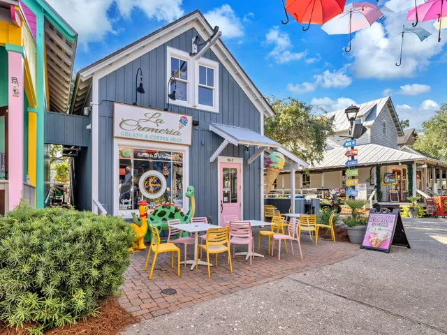 a view of a cafe with a table and chairs in front of it
