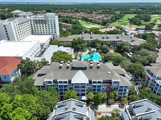 an aerial view of multiple houses with yard