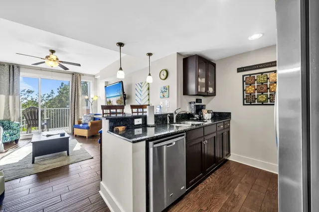 a kitchen with stainless steel appliances granite countertop a stove and cabinets