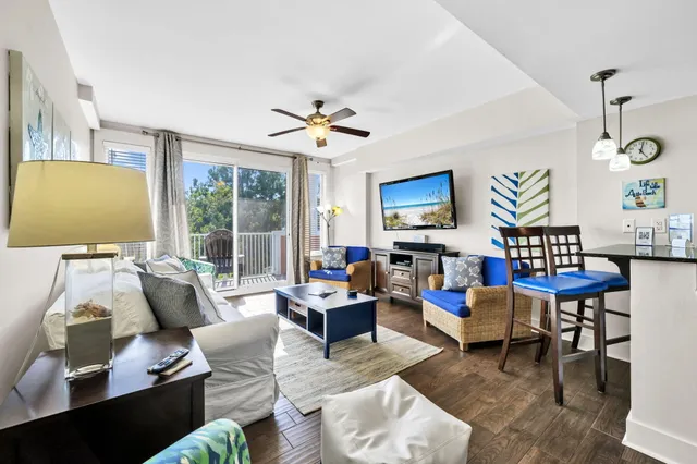 a living room with furniture fireplace and a large window