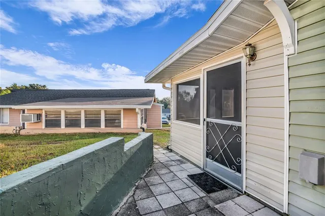 a white house that has tree in front of it
